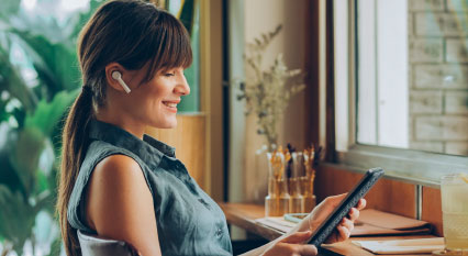 woman listening to phone wearing ear buds