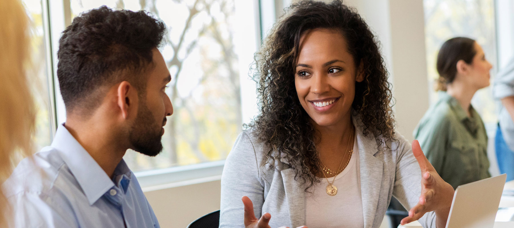 Woman talking with a male colleague.