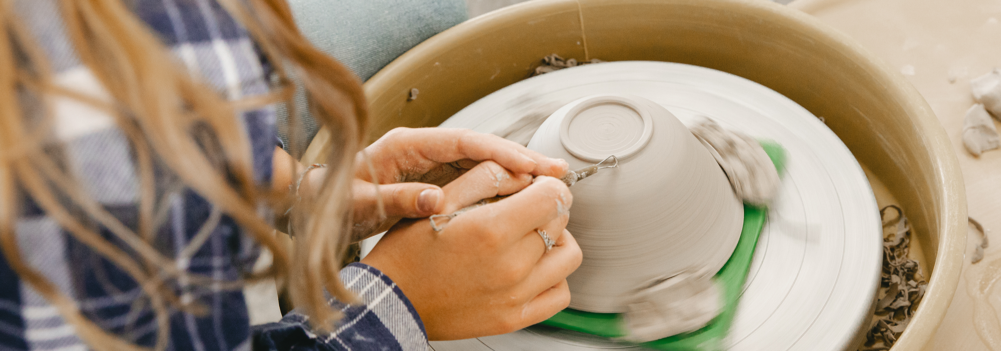 Student in Normandale Community College's art program creating pottery.