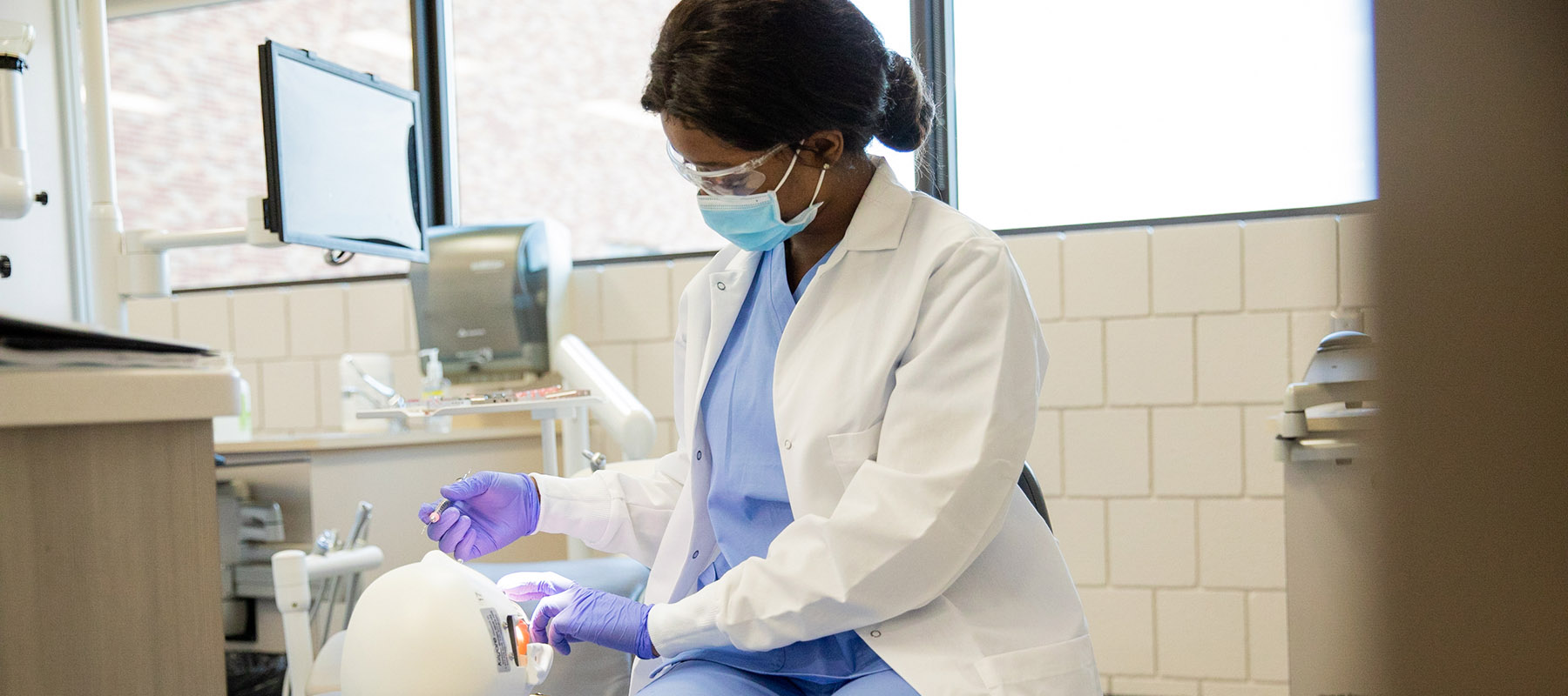 Student in Normandale's dental hygiene program performs hands-on learning tasks.