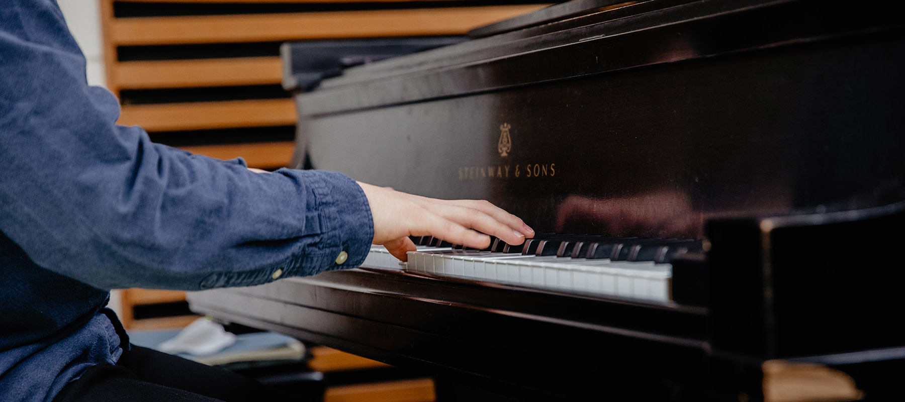 Student pursuing an associate's degree in music playing piano 