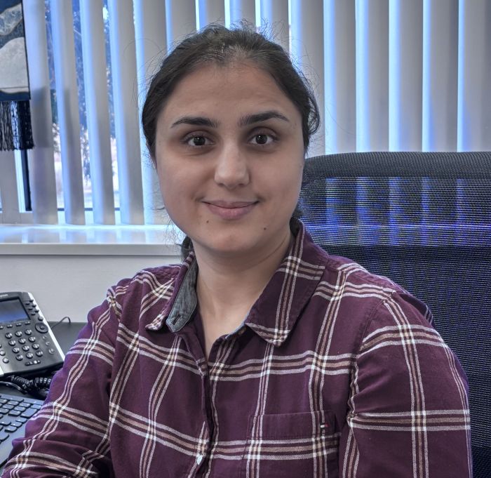 Picture of Lola looking directly at camera while sitting at a desk