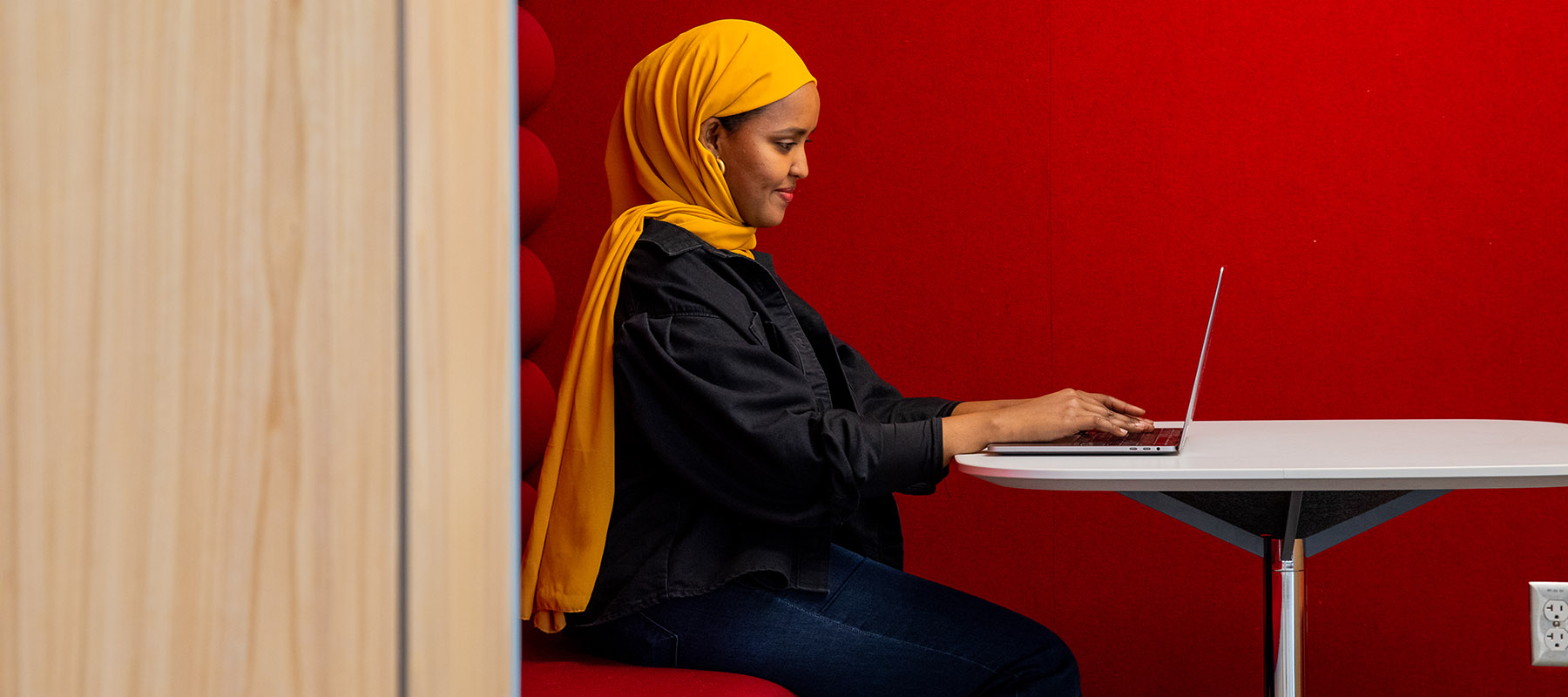 Normandale student logging in to one of her online community college courses with her laptop.