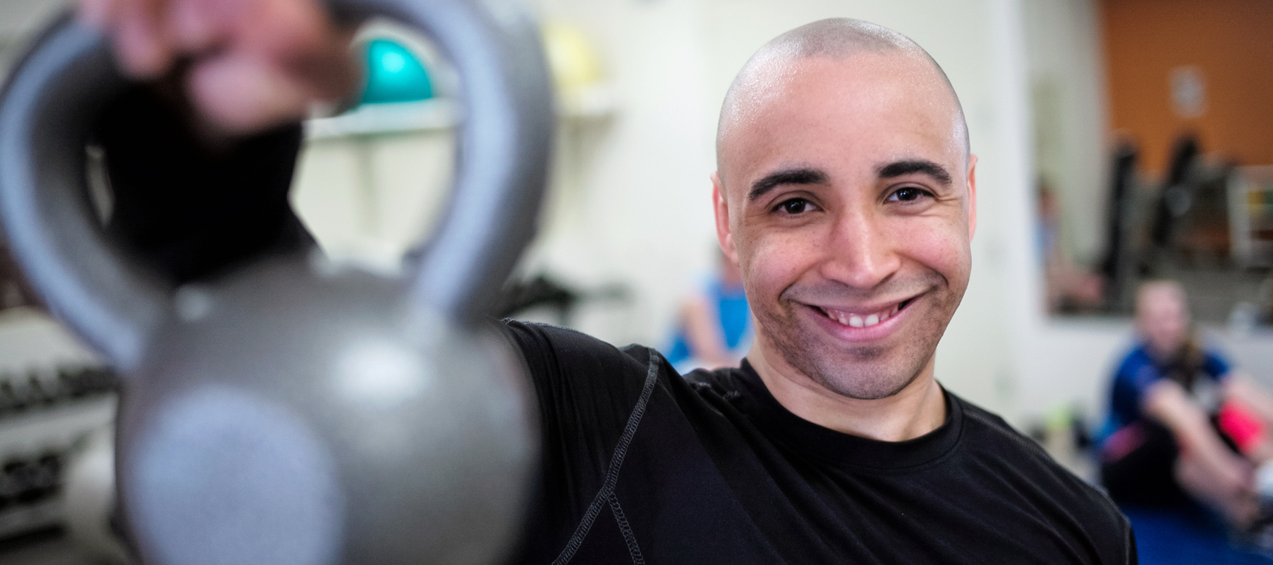 A student lifts weights in the fitness center.