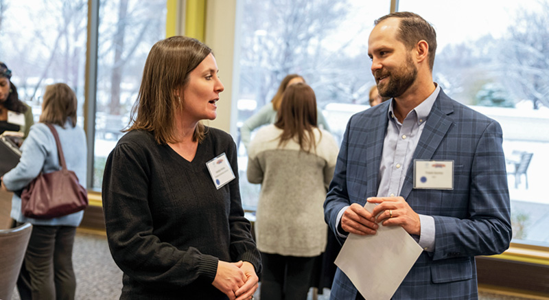 Two students in Normandale's continuing education department chat at a function.