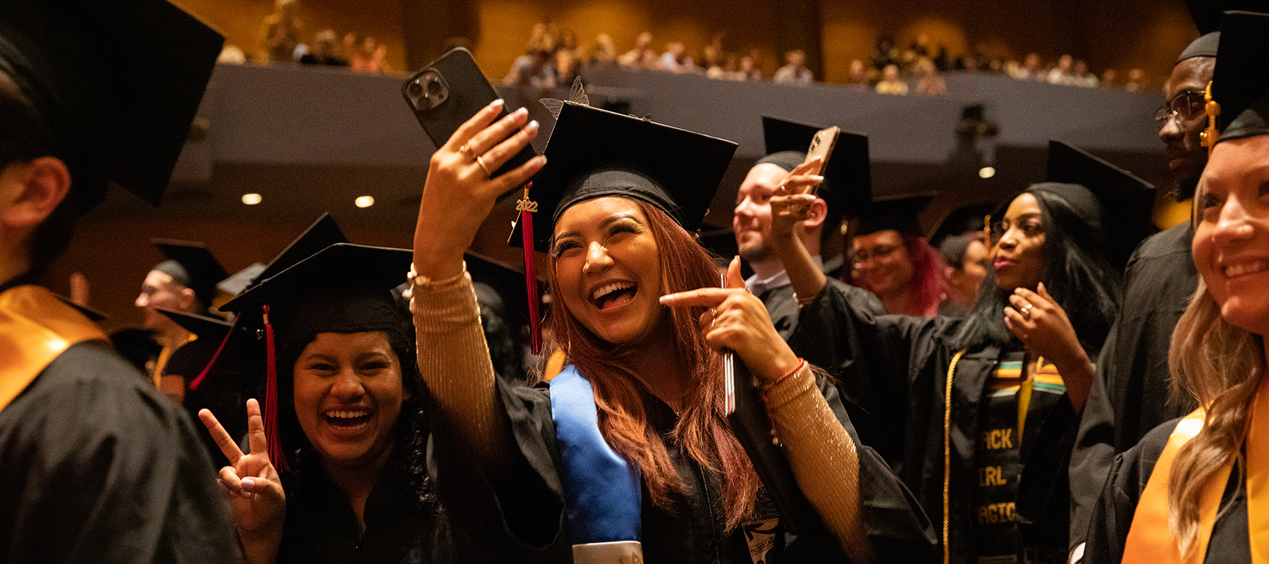 A Normandale student takes a celebratory selfie at Commencement.